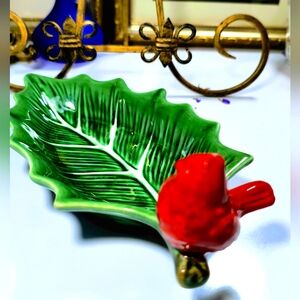 Charming leaf-shaped dish. Features a vibrant red bird. Perfect for decor or ser